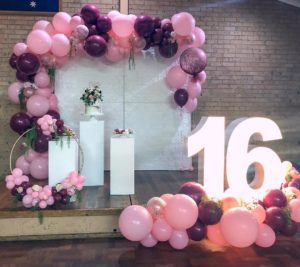 Quinceanera image: A table topped with lots of pink and white balloons