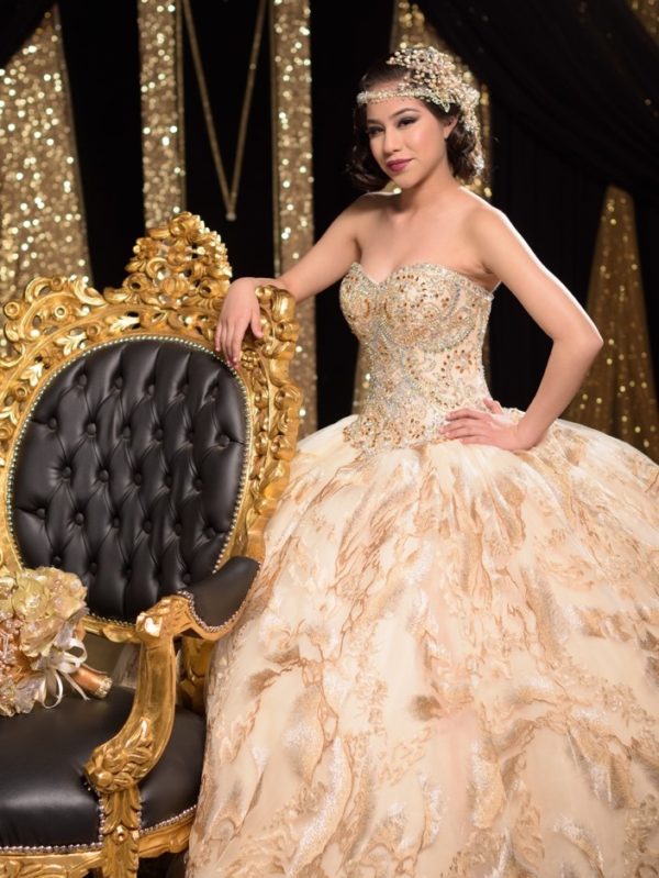 A woman in a Quinceanera dress sitting on a chair, reminiscent of the Great Gatsby era