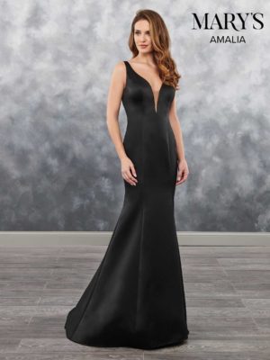 Quinceanera gown, a woman in a black dress standing on a wooden floor