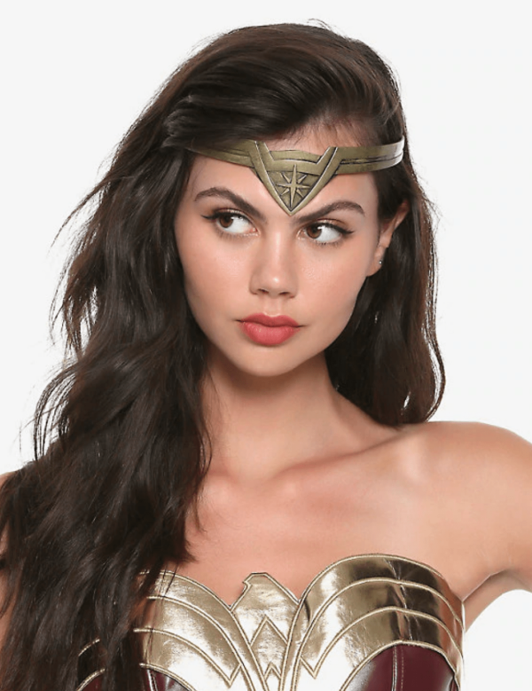 girl in a Wonder Woman tiara and outfit looking to the side