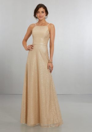 Quinceanera gown, a woman in a gold dress posing for a picture