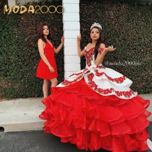Two women in red Quinceañera dresses posing for a picture