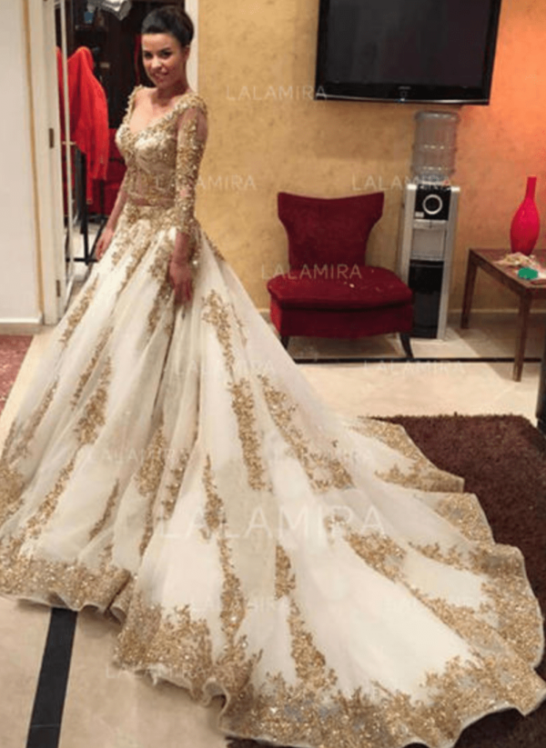 White sleeved ballgown with gold embroidery