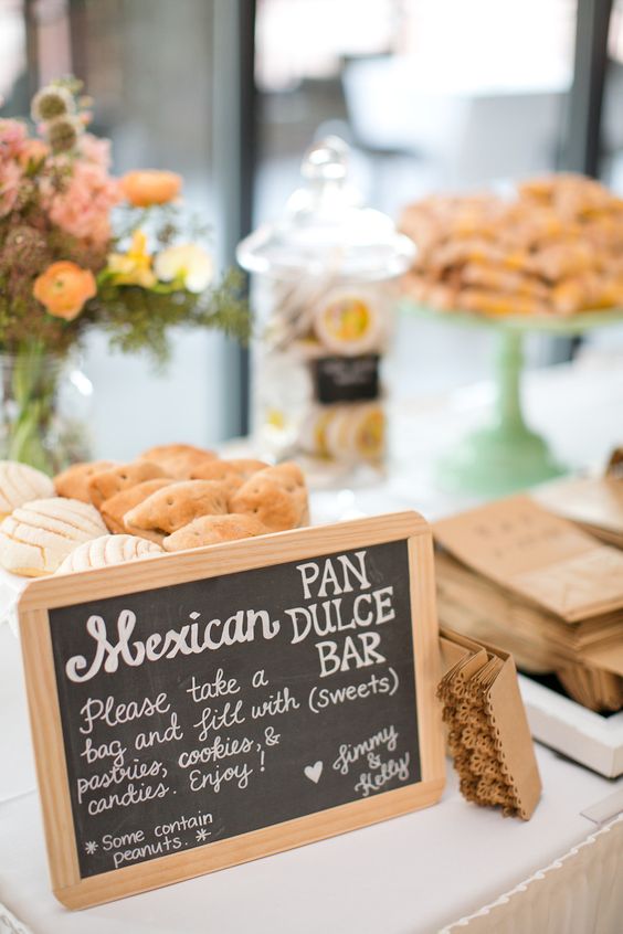Quinceanera dessert table with Mexican pastries, including pan dulce and various other sweet treats