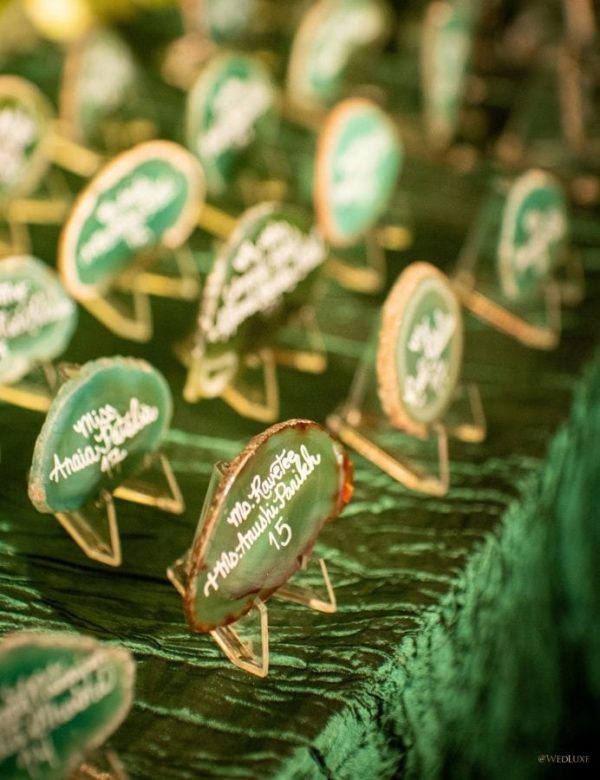 Close up of a Quinceanera table in Land of Oz with multiple green and white signs