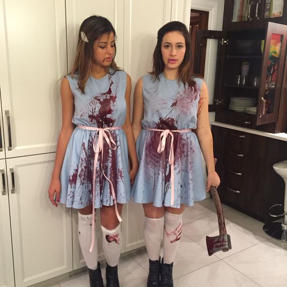 Two women dressed as zombies in The Shining Halloween costumes standing next to each other