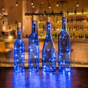 A stunning Quinceanera theme inspired by the Starry Night. The image features a group of bottles with blue lights in them.