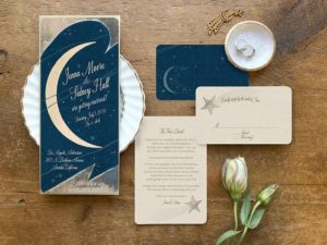 Quinceanera invite with celestial theme, featuring a table adorned with a plate of food and a flower