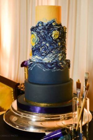 A stunning three-tiered Quinceanera cake with a Starry Night theme, featuring a starry sky on top.