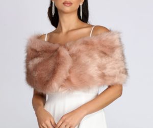 A woman wearing a pink fake fur stole