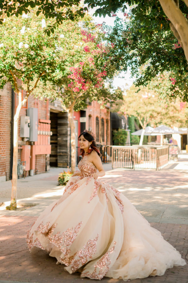 Quinceanera gown, a woman in a Quinceanera dress walking down a street