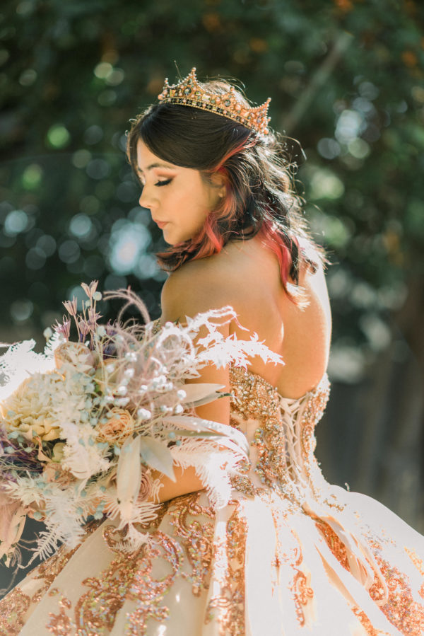 Quinceanera, a woman in a Quinceanera dress holding a bouquet