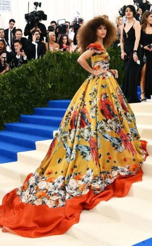 Quinceanera: Zendaya, a woman in a floral dress standing on stairs