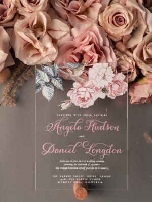 A close-up of a Quinceanera invitation surrounded by a floral bouquet