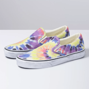 A pair of tie dye Quinceanera Vans Slip-On shoes on a white surface.