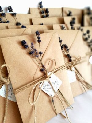 Quinceanera invitation wrapping ideas. A bunch of brown envelopes tied up with twine.