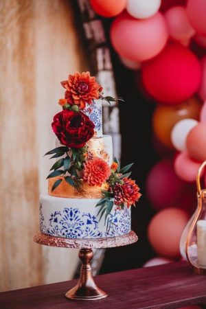 A Mexican inspired Quinceanera cake, featuring three tiers and adorned with flowers