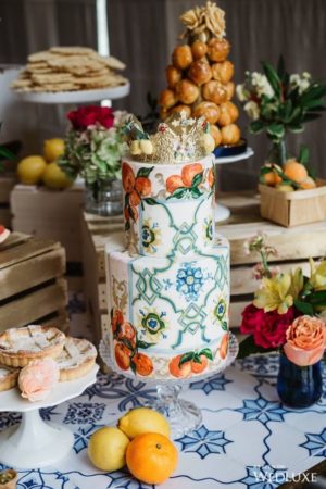 A Quinceanera brunch table topped with a cake covered in oranges
