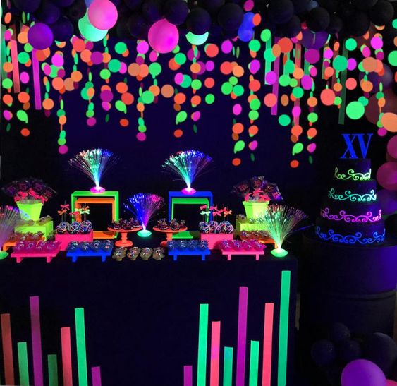 Quinceanera party decoration with neon balloons and blacklight