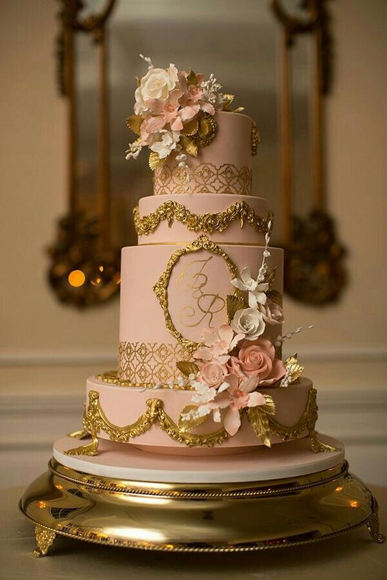 A pink and gold Quinceanera cake on a gold platter