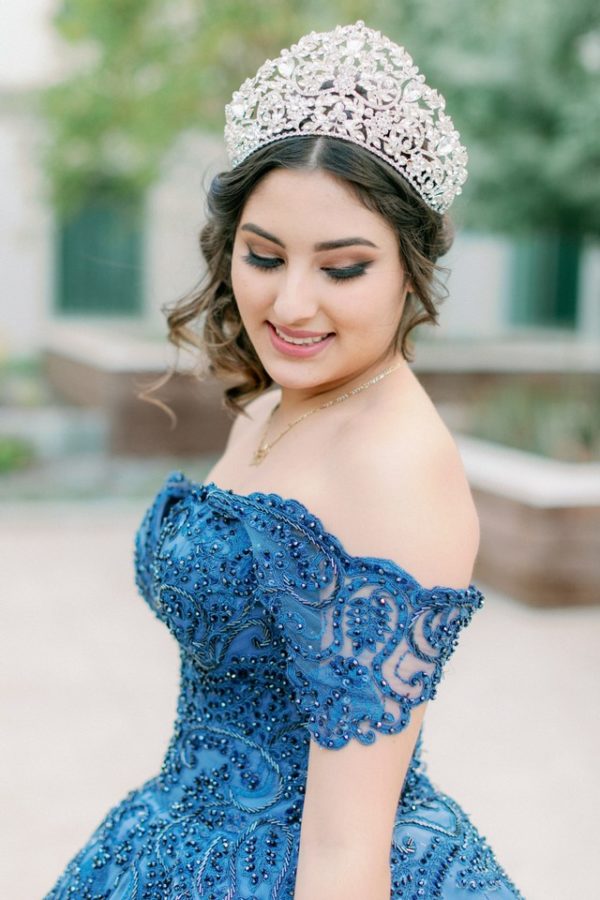 Quinceanera Gown, a woman wearing a blue dress and a tiara