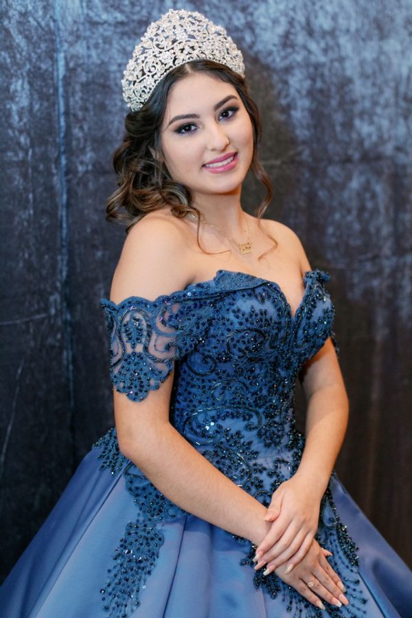 Quinceanera gown, a woman wearing a blue dress and a tiara