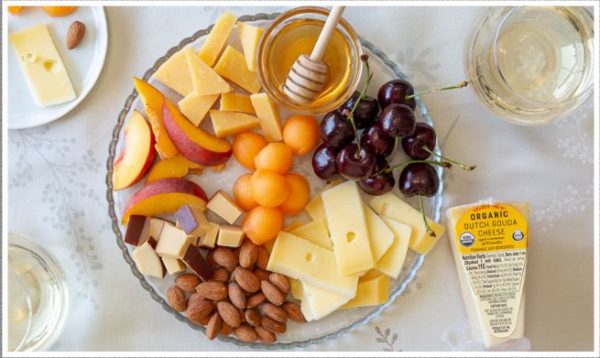A plate of fruit and cheese for a Quinceanera celebration.