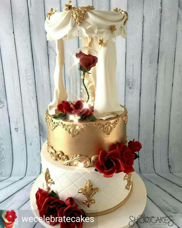 A three-tiered Quinceanera cake with red roses, inspired by Beauty and the Beast