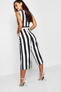Quinceanera fashion model wearing a black and white striped jumpsuit