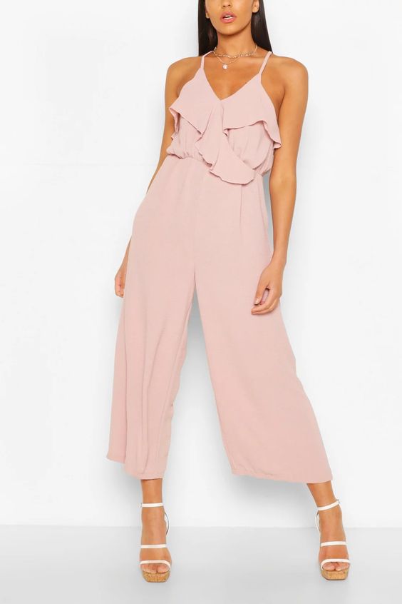 A fashion model wearing a pink jumpsuit for a Quinceanera