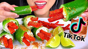 A woman holding a plate of Jalapeno Cream Cheese with Takis