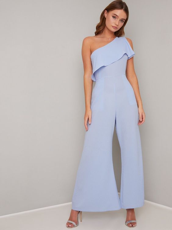 A woman wearing a light blue jumpsuit by Chi Chi London