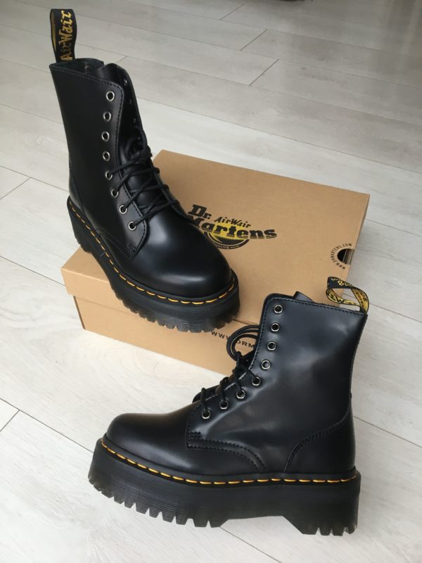 A pair of black Dr. Martens Jadon boots sitting on top of a box, perfect for a Quinceanera celebration