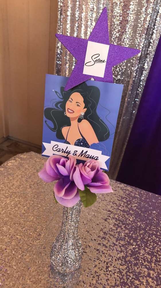 Selena themed Quinceanera party with a purple flower in a silver vase and a purple star on top