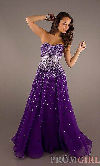Quinceanera: A woman in a long purple dress posing for a picture, wearing a stunning gown