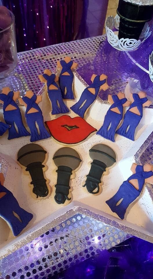 A Quinceanera theme birthday, featuring a table topped with cookies and decorated cookies