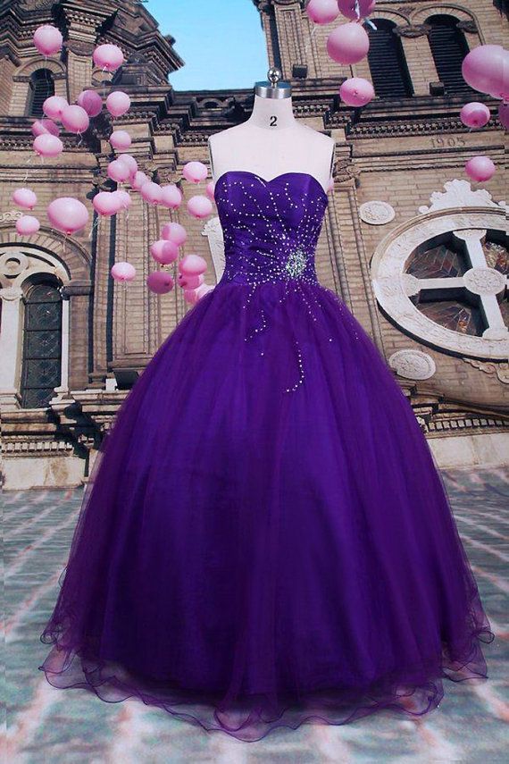 Selena-themed Quinceanera dresses displayed in front of a building