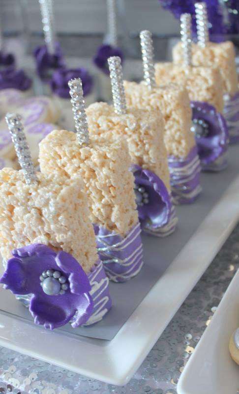 A Quinceanera-themed table filled with purple and white desserts, including Rice Krispies Treats.