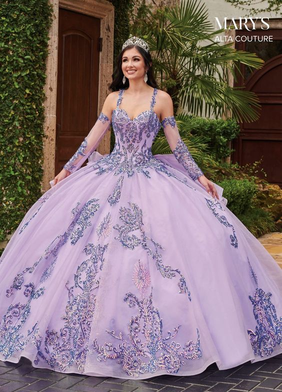 Mary's Bridal Quinceanera dress. A woman in a purple ball gown posing for the camera in a Quinceanera event.