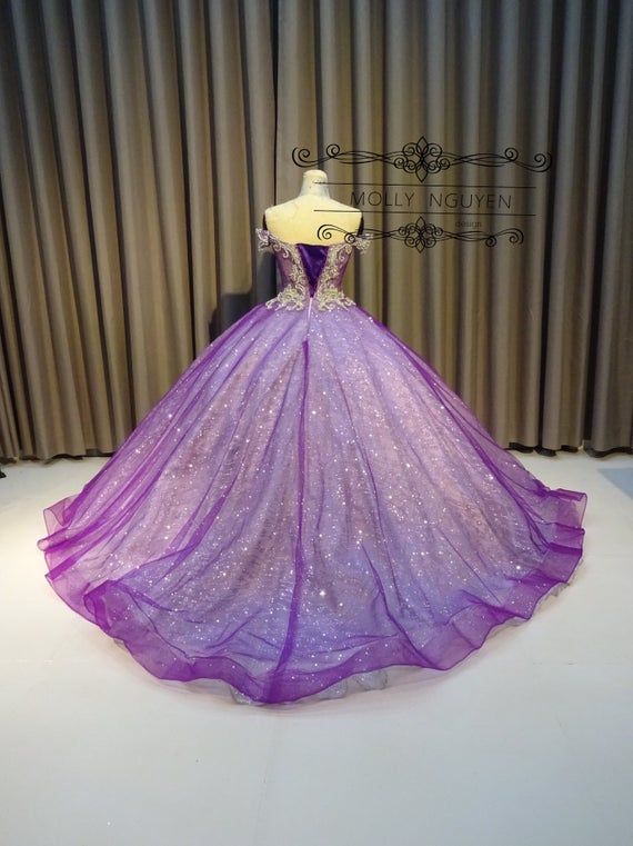 A purple Quinceañera dress displayed on a mannequin