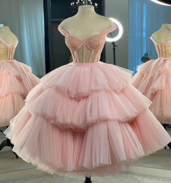 A pink ball gown dress on a mannequin for Quinceanera