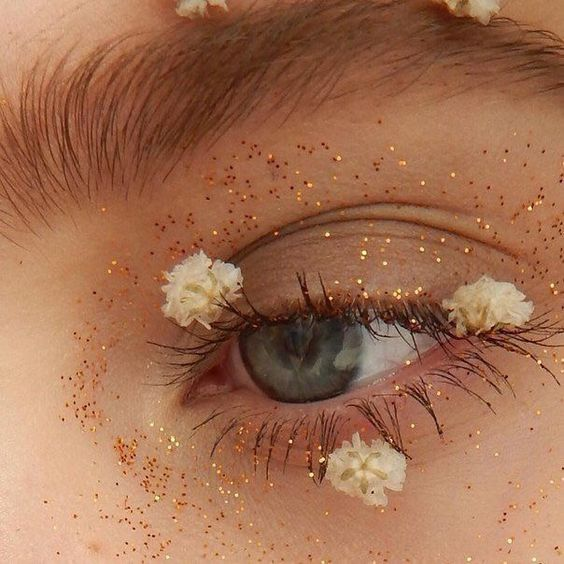 A close up of a person's eye with glittery eyeshadow, perfect for Quinceanera.