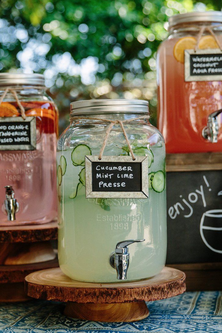 Quinceanera drinks dispenser featuring three jars of labeled drinks