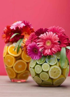 Floral design for Quinceanera, couple of vases filled with fruit and flowers