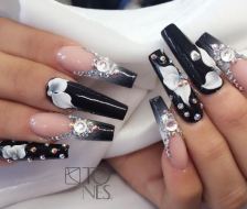 A woman holding a black and white manicure for her Quinceanera nail manicure