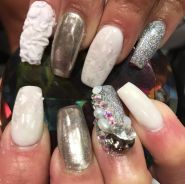 A person holding a pair of white and silver nails for a Quinceanera hairstyle
