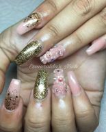 A person with a pink and gold Quinceanera manicure