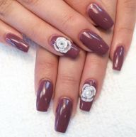 Close up of a person's hand with a purple manicure