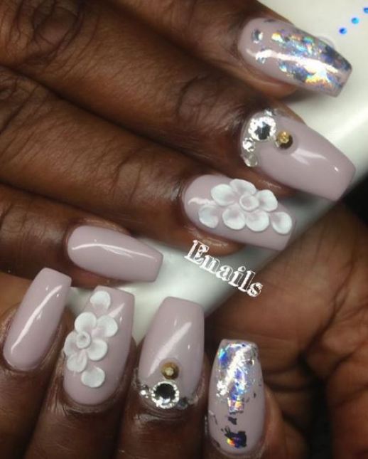 A woman holding a bottle of nail polish, getting a Quinceanera manicure