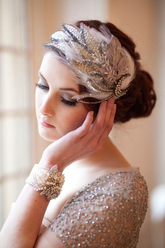 Quinceanera: A woman in a silver dress with a feathered headband showing her nails